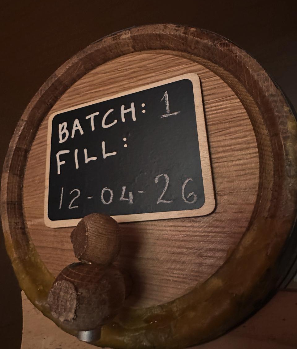 Barrel 1, fill date 12-04-26, marked by hand on a chalkboard.