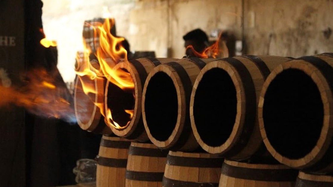 The barrel being toasted with fire.